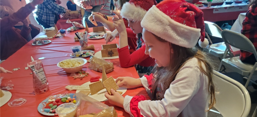 girl decorating gingerbread house