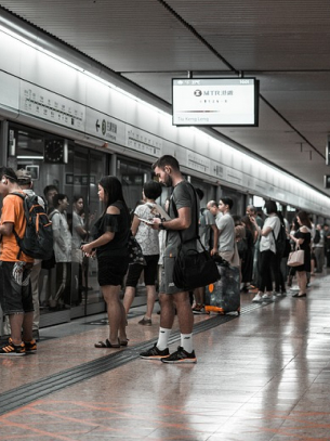 group of people standing in subway station