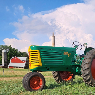 Tractor with a barn in the background